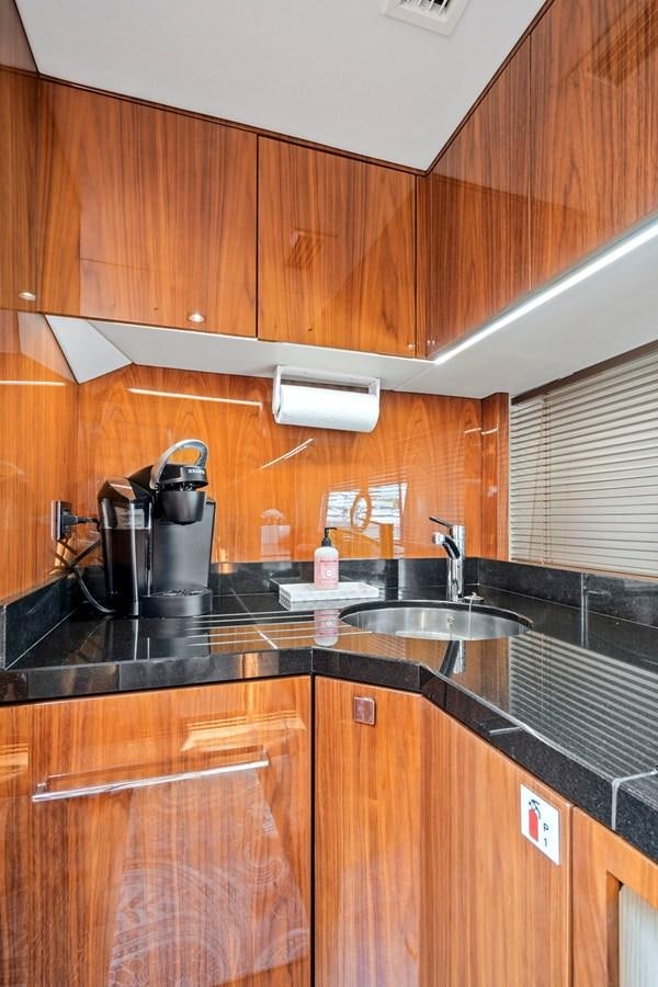 a kitchen with wooden cabinets aboard ONCE AROUND Yacht for Sale