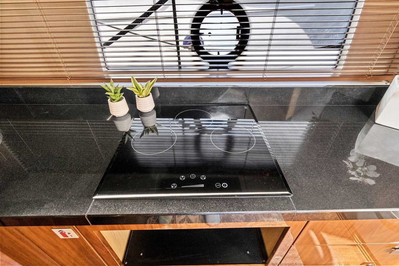 a black stove with a potted plant on top aboard ONCE AROUND Yacht for Sale