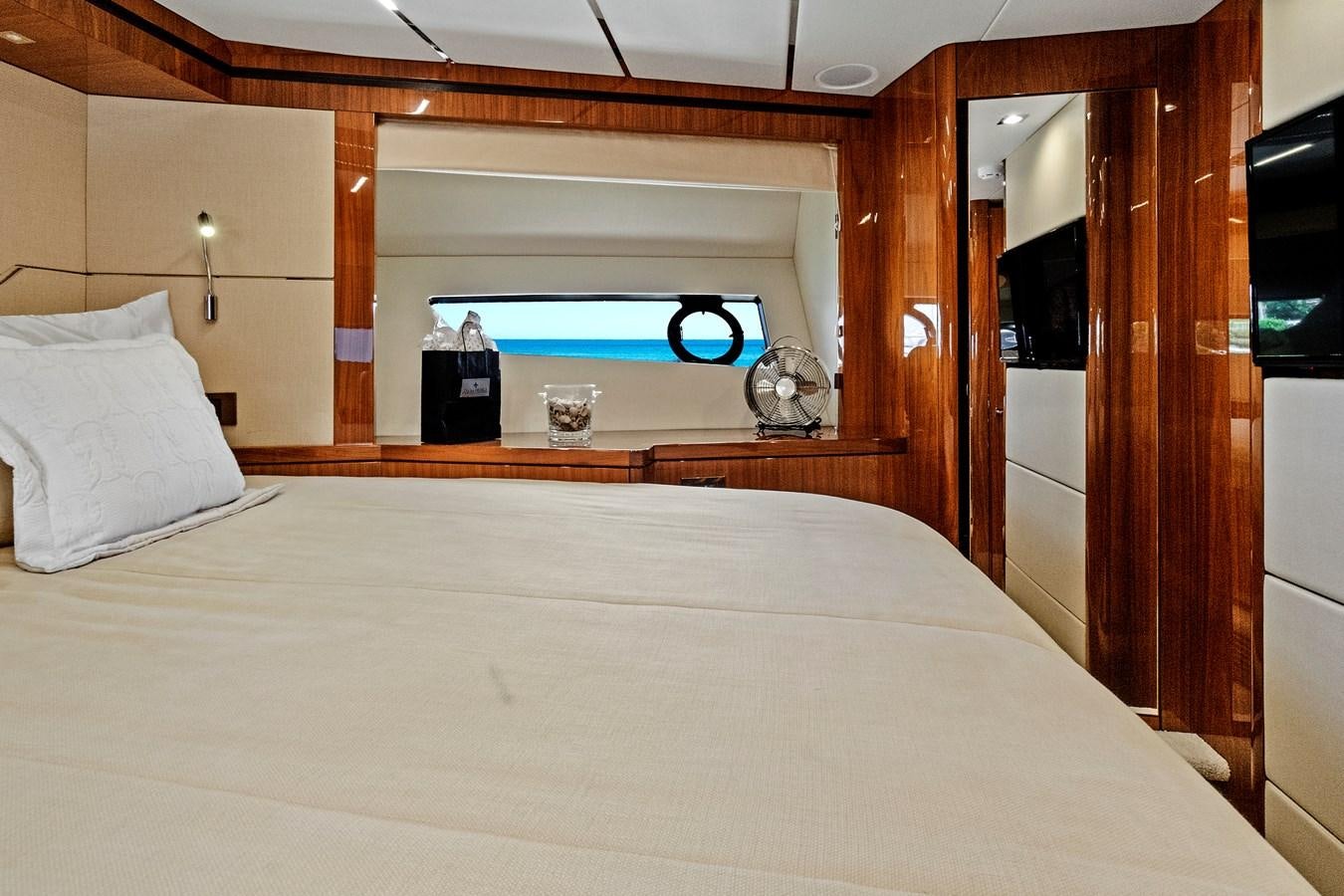 a bed with a white sheet and a blue object on the side aboard ONCE AROUND Yacht for Sale