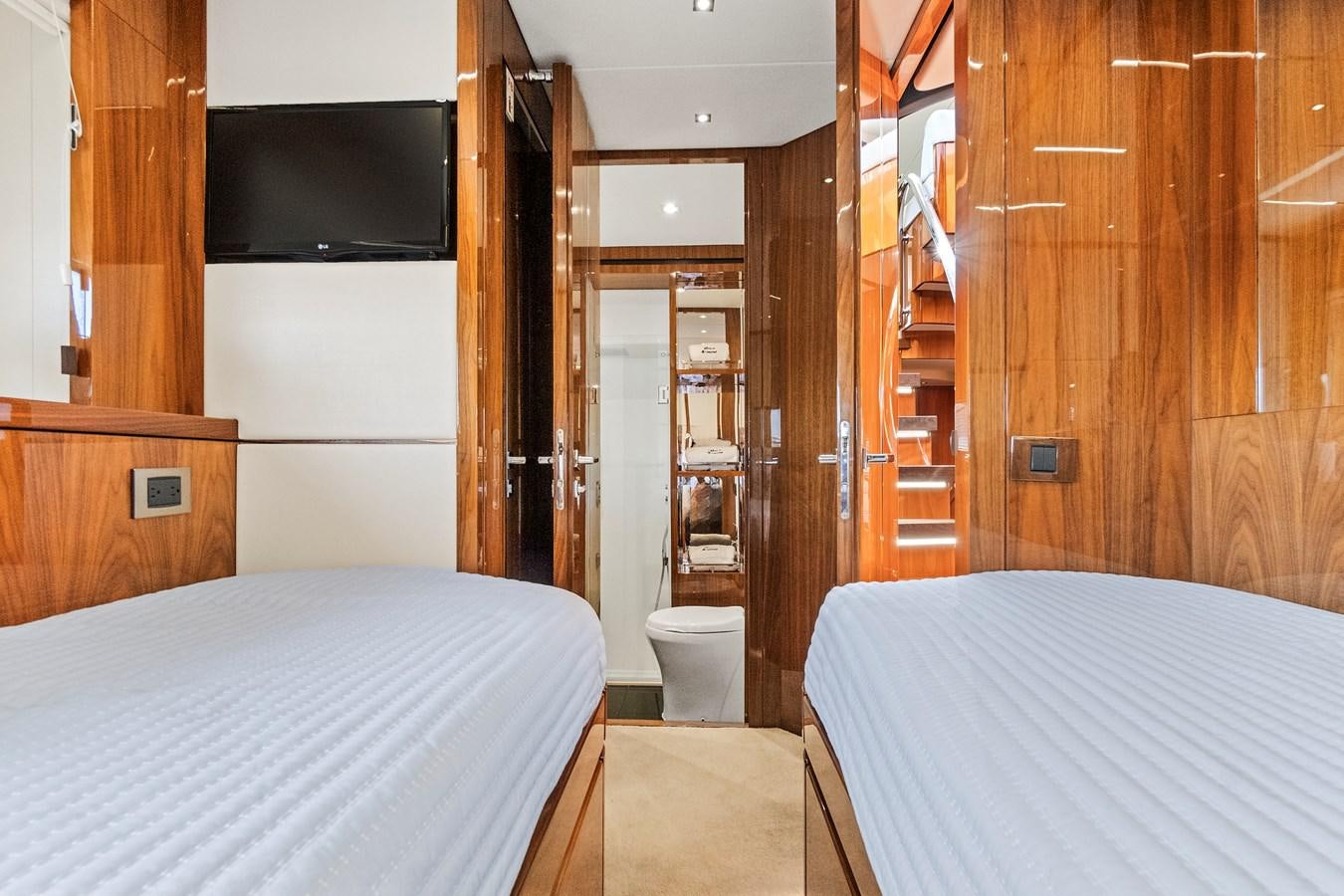 a room with a bed and a television aboard ONCE AROUND Yacht for Sale