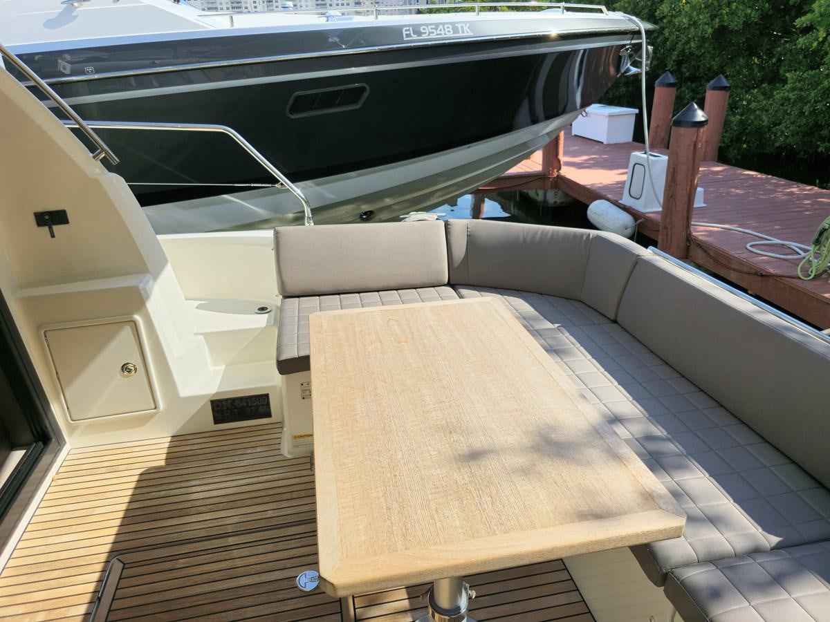 a deck with a table and chairs aboard OPUS ONE Yacht for Sale