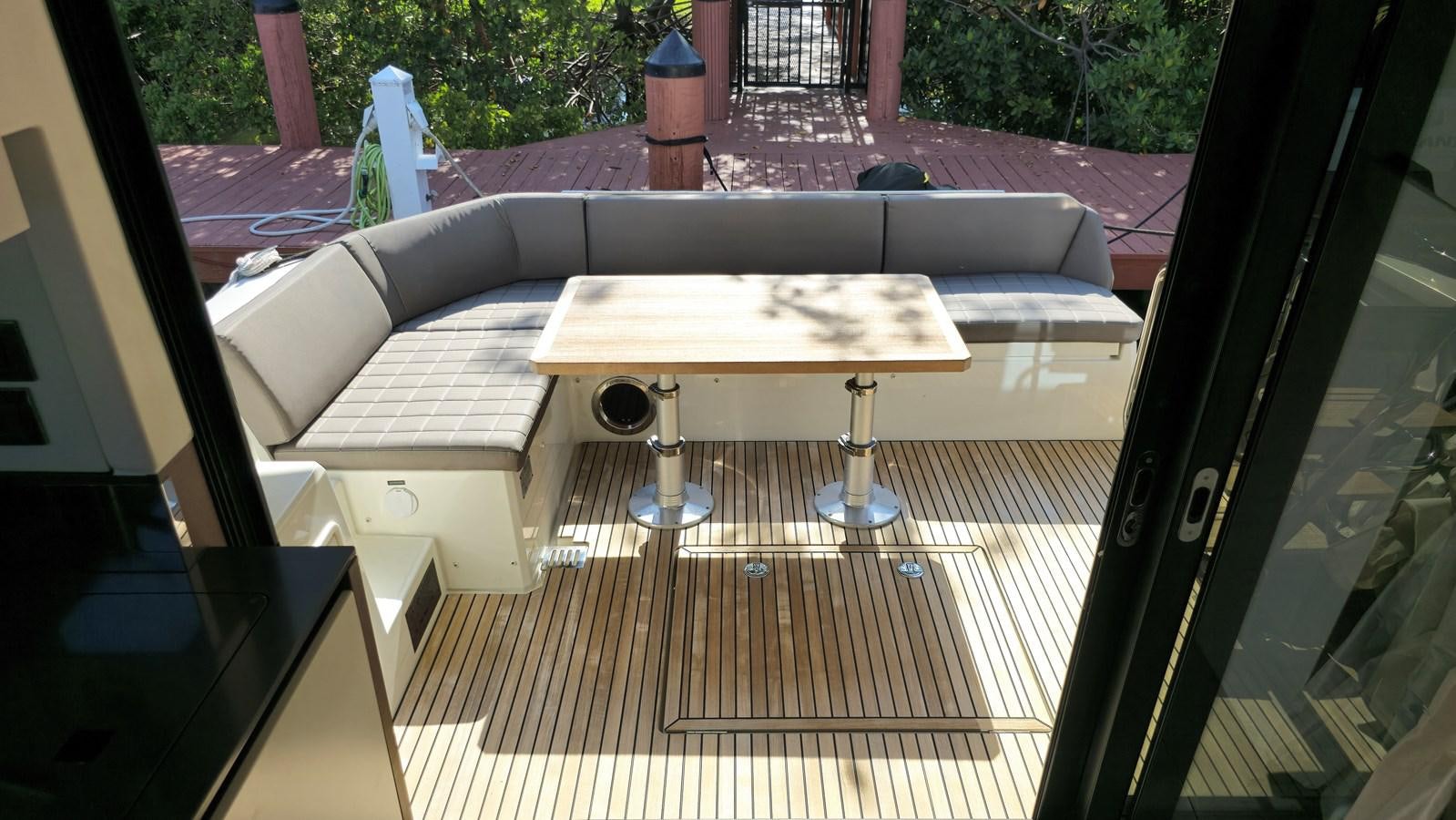 a table with a bench aboard OPUS ONE Yacht for Sale