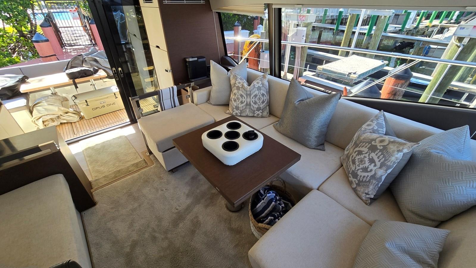 a living room with a couch and coffee table aboard OPUS ONE Yacht for Sale
