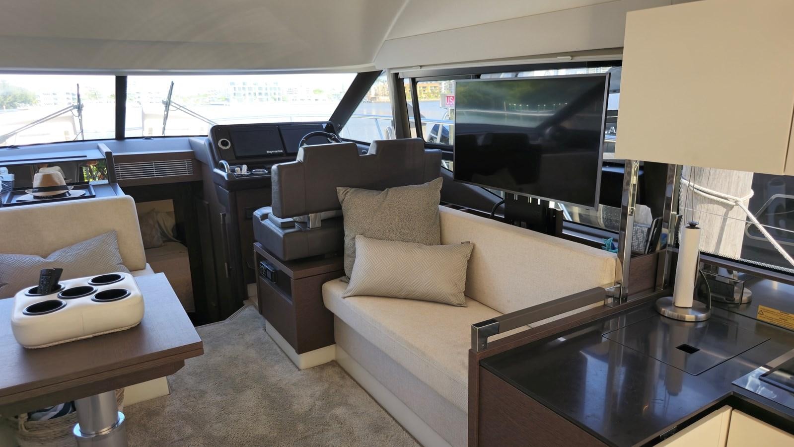 a living room with a couch and a television aboard OPUS ONE Yacht for Sale