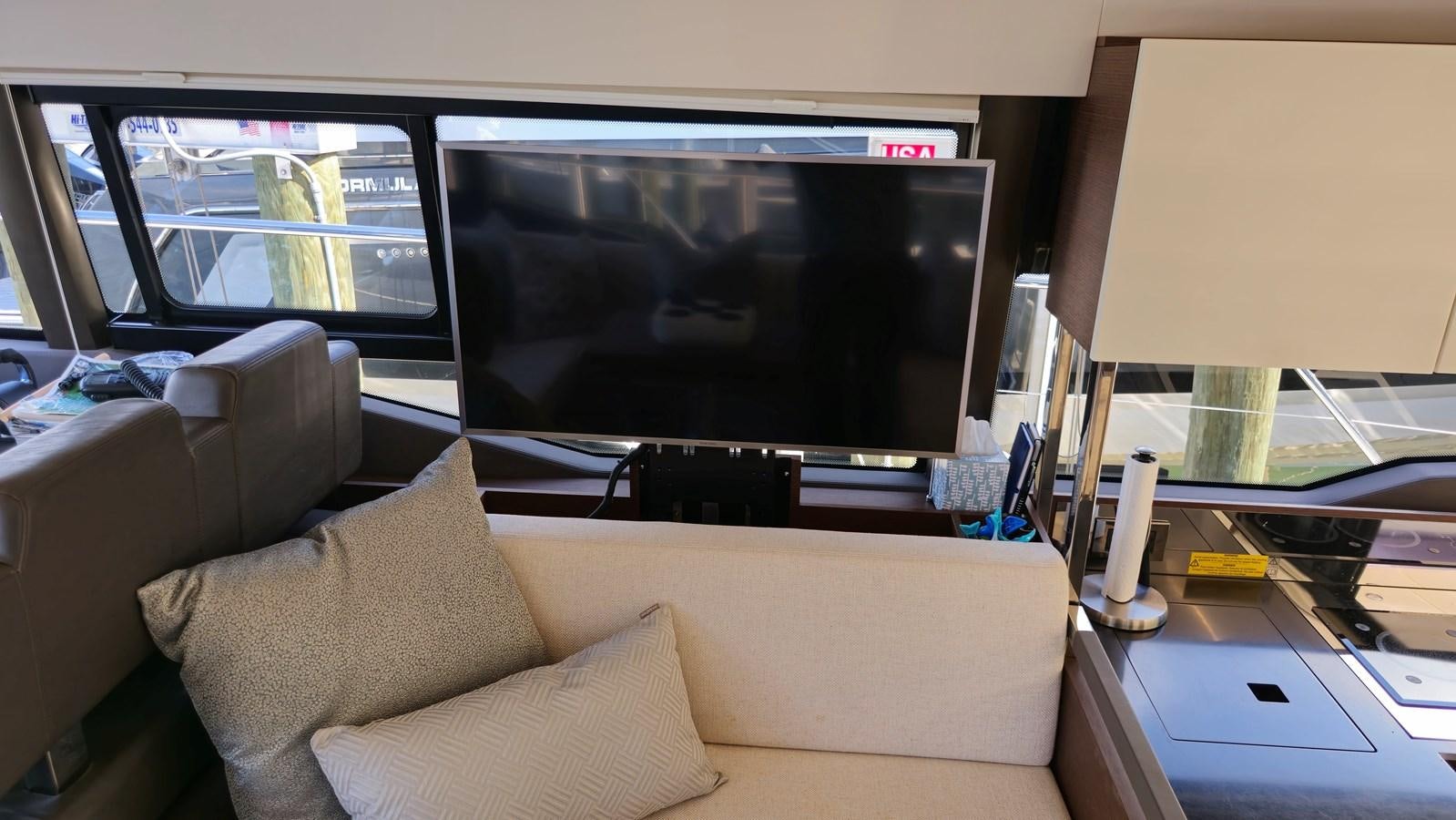 a living room with a couch and a tv aboard OPUS ONE Yacht for Sale