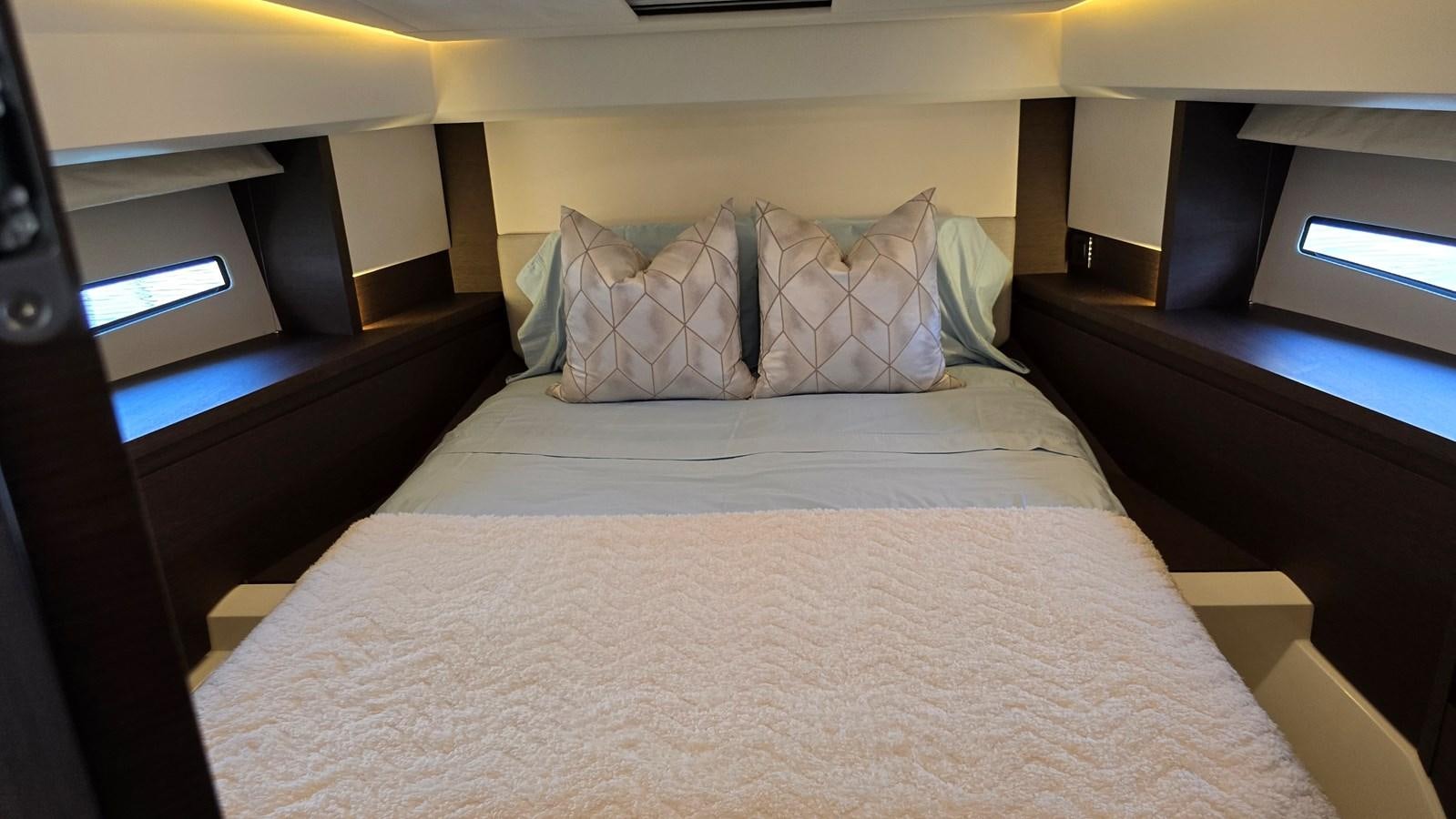 a bed with a white comforter aboard OPUS ONE Yacht for Sale