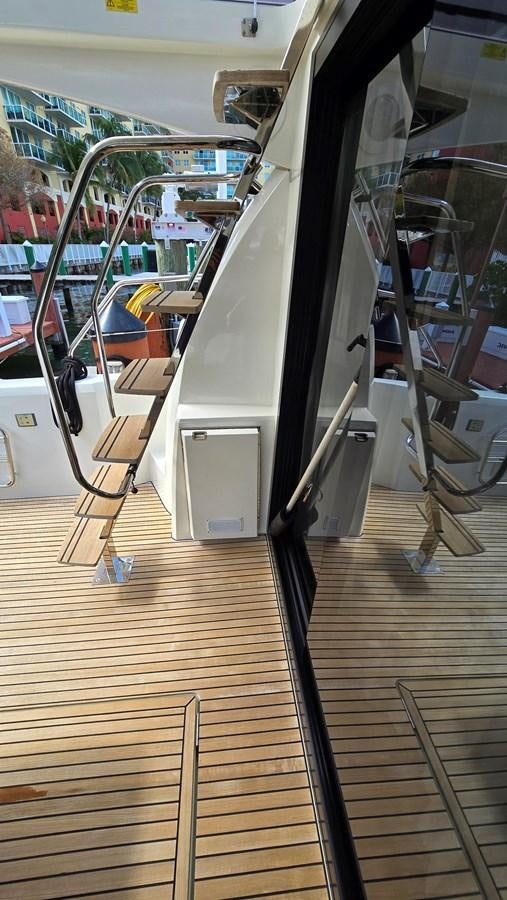 a wooden deck with a metal railing aboard OPUS ONE Yacht for Sale