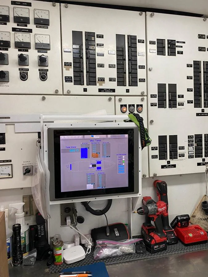 a computer with a monitor and tools aboard BUCKPASSER Yacht for Sale
