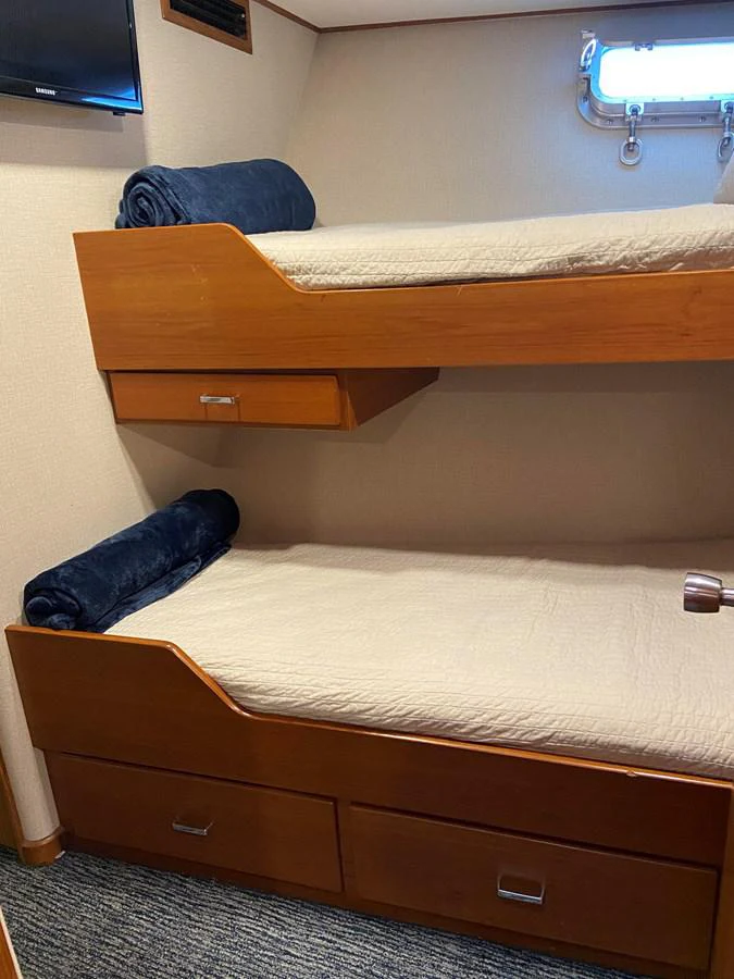 a wooden shelf with a bed aboard BUCKPASSER Yacht for Sale