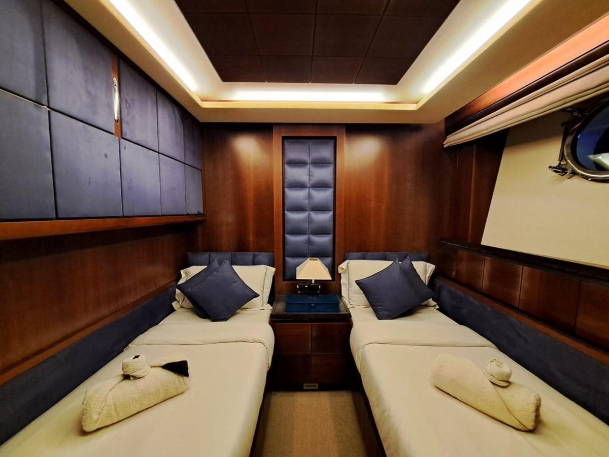 a room with a bed and a wood wall aboard HYE SEAS II Yacht for Sale