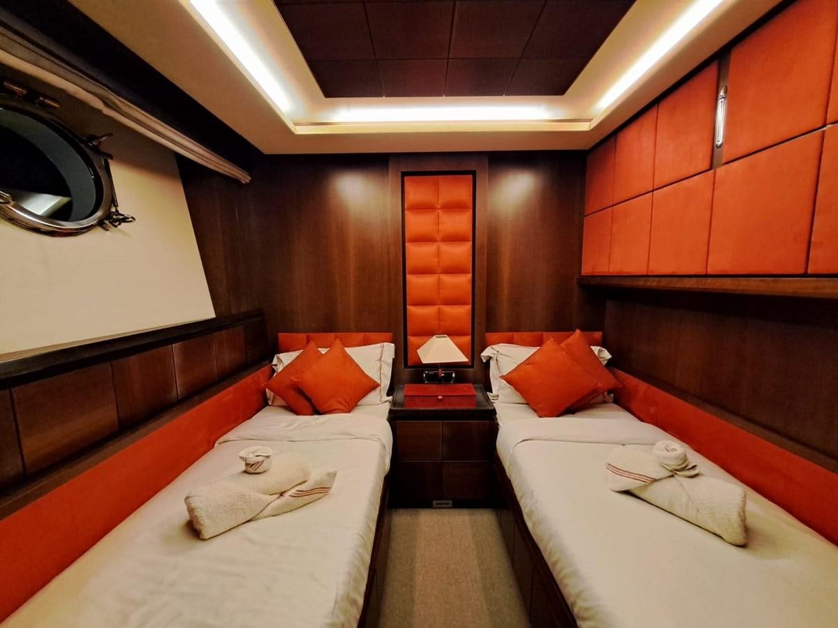 a room with beds and a mirror aboard HYE SEAS II Yacht for Sale