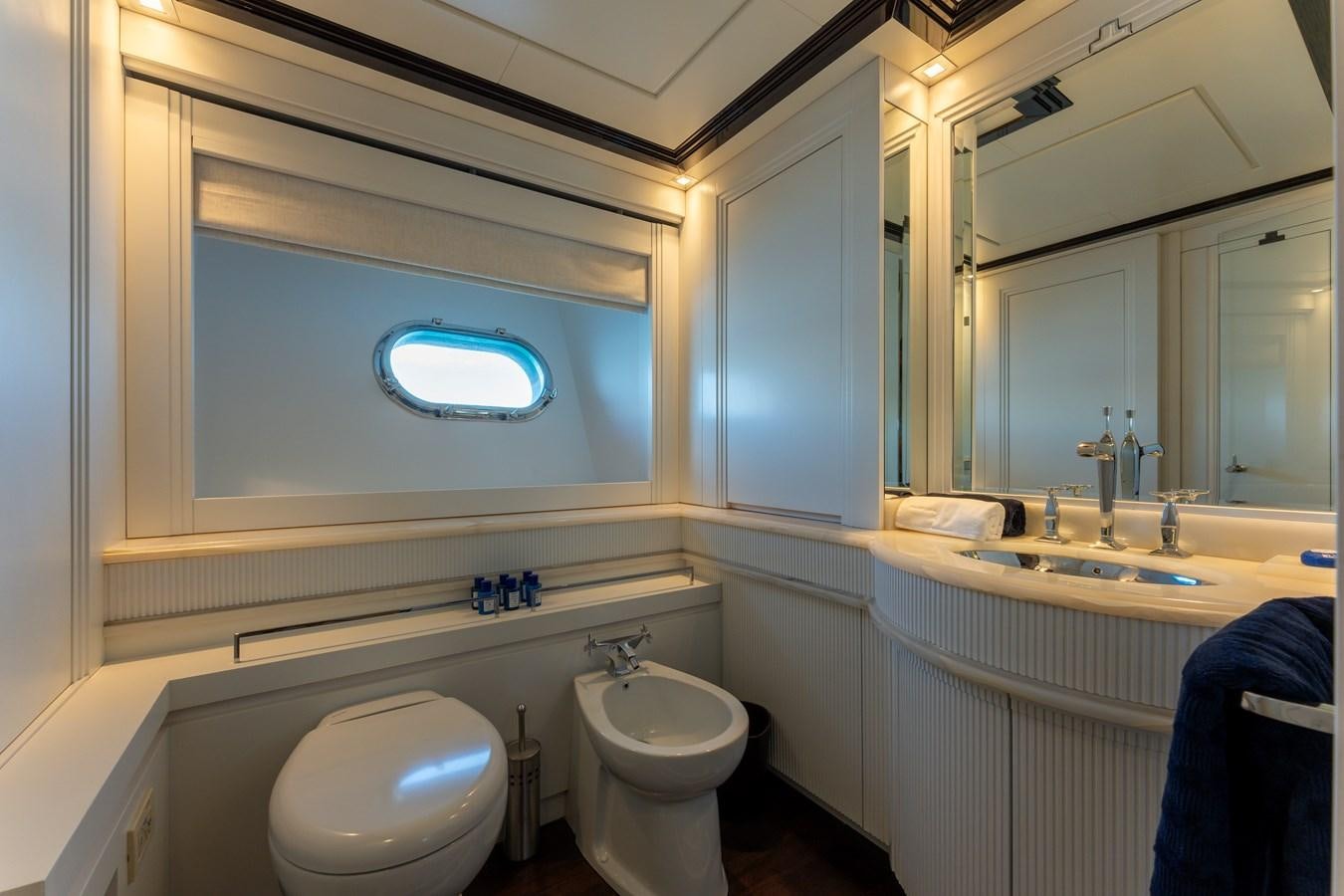 a bathroom with a toilet and a sink aboard DOMUS Yacht for Sale