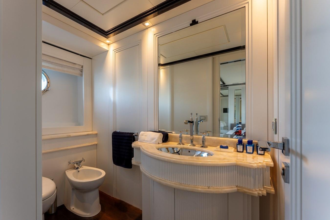 a bathroom with a sink and a mirror aboard DOMUS Yacht for Sale