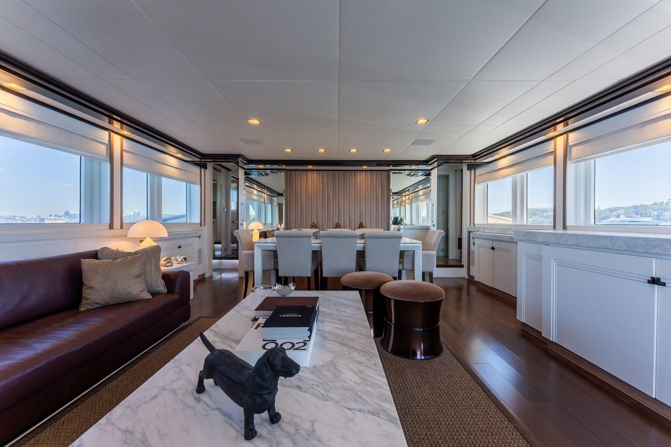 a dog on a couch in a living room aboard DOMUS Yacht for Sale