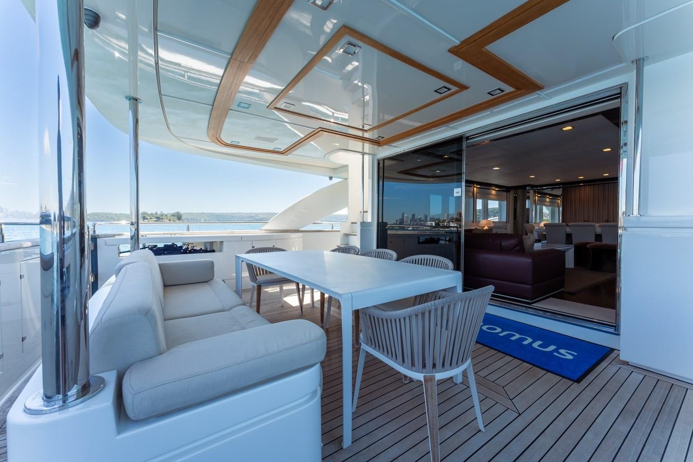 a room with a table and chairs aboard DOMUS Yacht for Sale