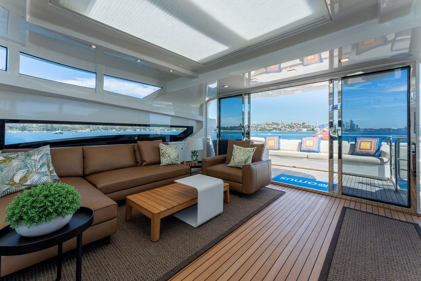 a living room with a large patio aboard DOMUS Yacht for Sale