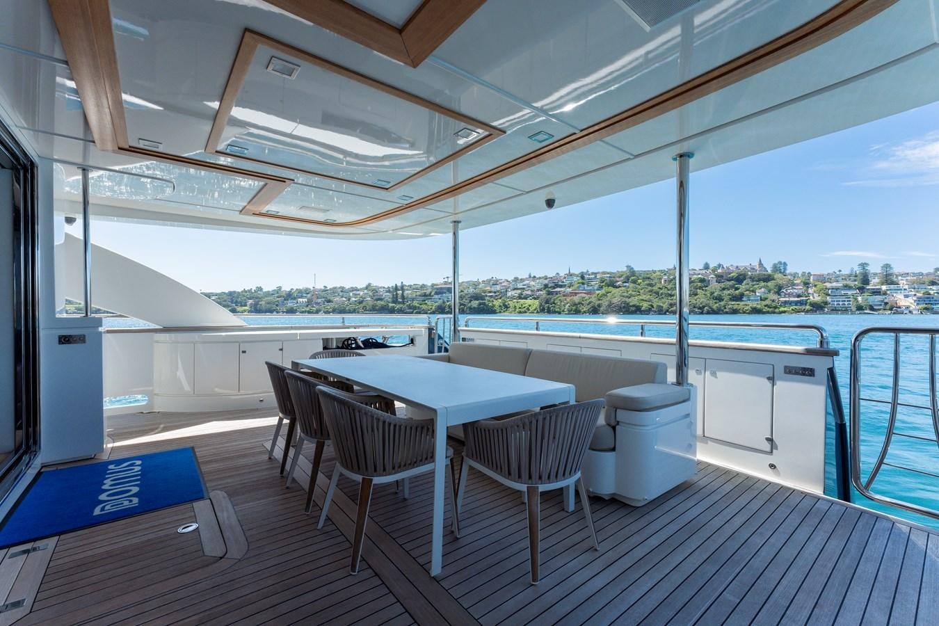 a table and chairs on a deck aboard DOMUS Yacht for Sale