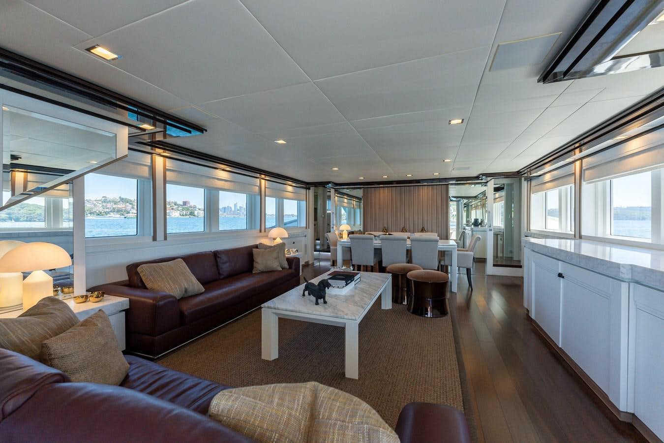 a living room with a couch and a table aboard DOMUS Yacht for Sale
