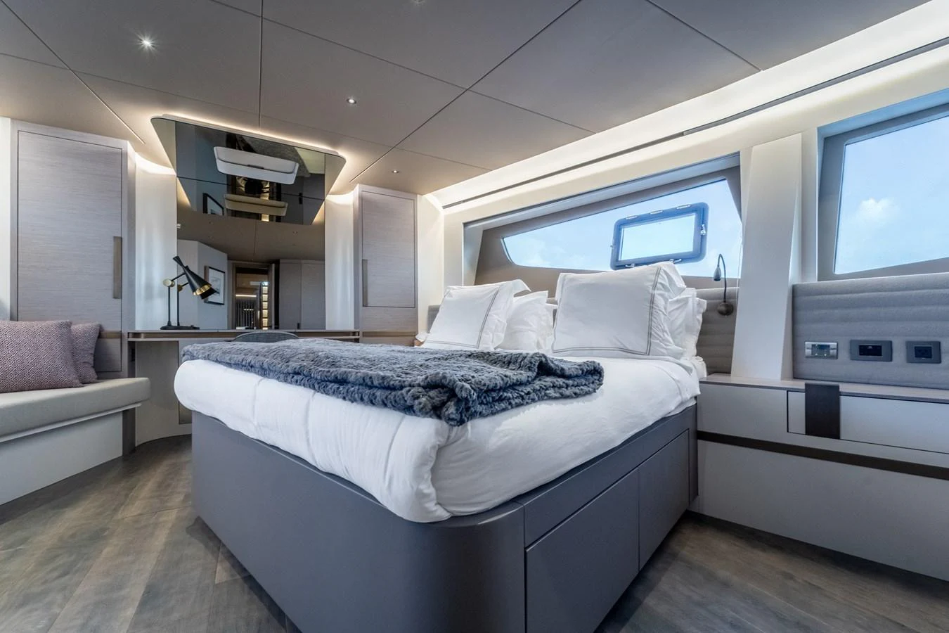 a bedroom with a bed and a couch aboard EXIT STRATEGY Yacht for Sale