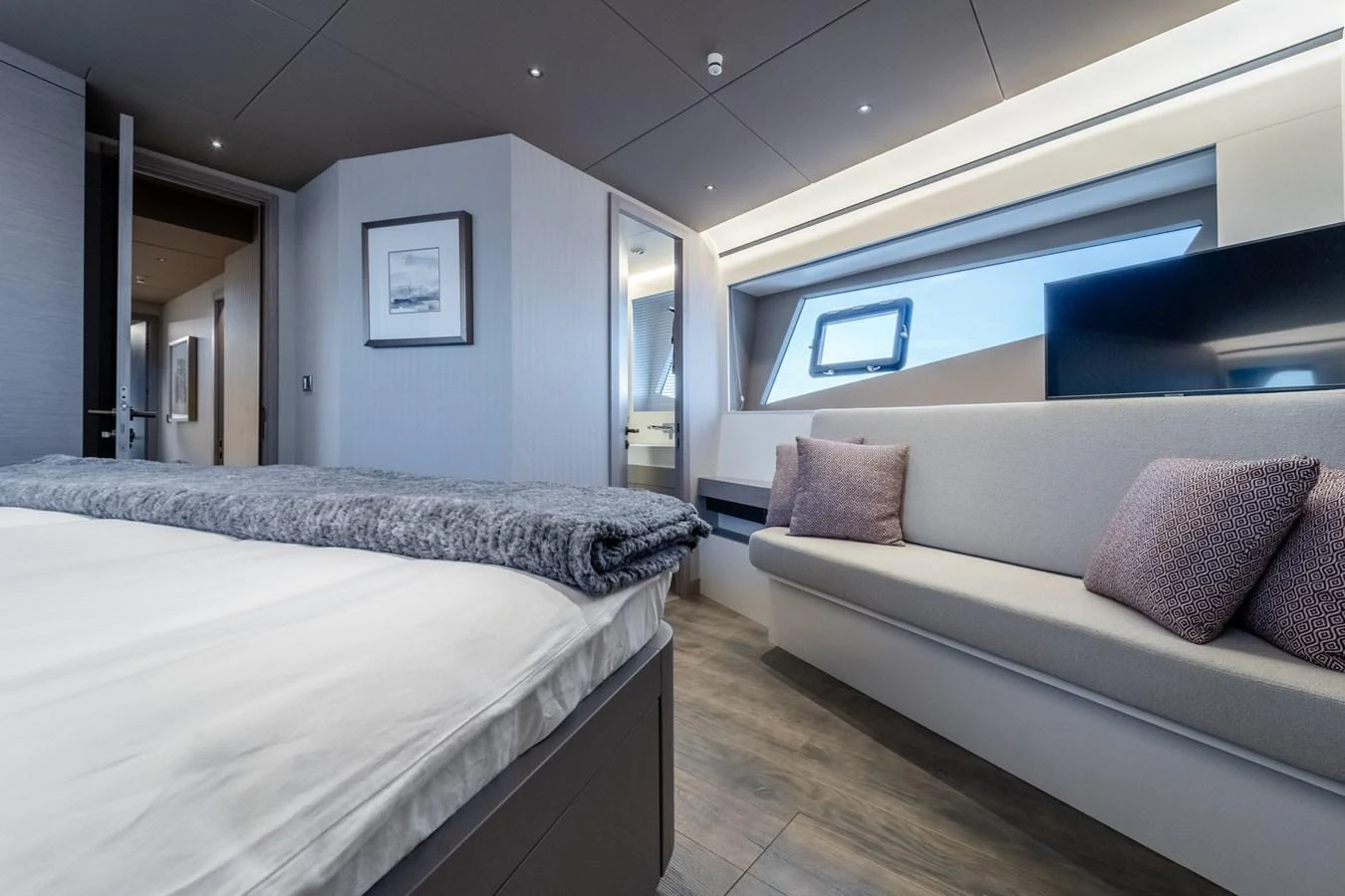 a bedroom with a bed and a couch aboard EXIT STRATEGY Yacht for Sale