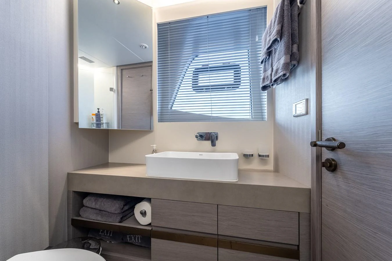 a bathroom with a sink and mirror aboard EXIT STRATEGY Yacht for Sale