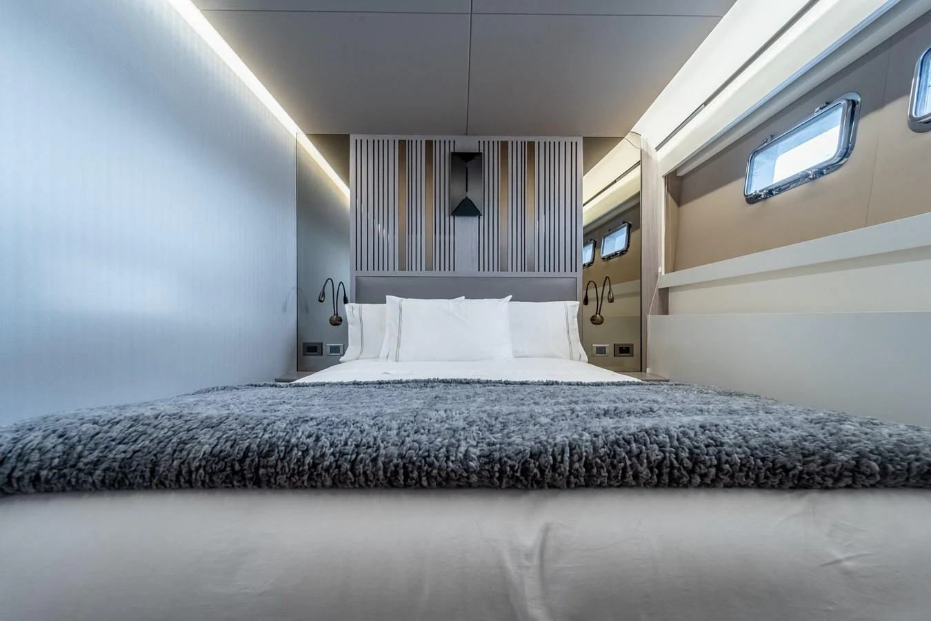a bed with a black and white bed spread aboard EXIT STRATEGY Yacht for Sale