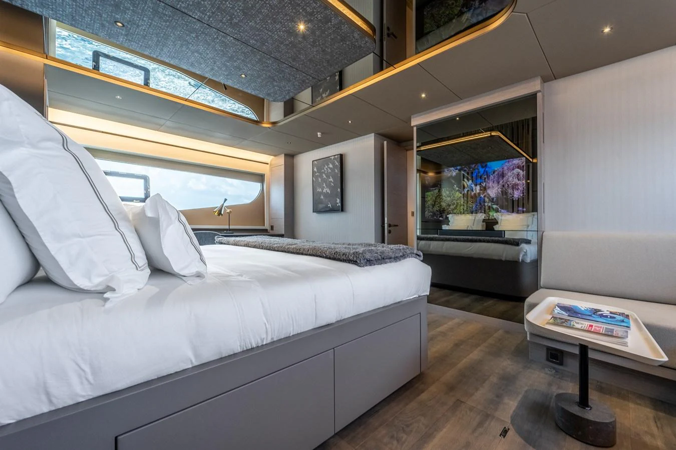 a bedroom with a bed and a table aboard EXIT STRATEGY Yacht for Sale