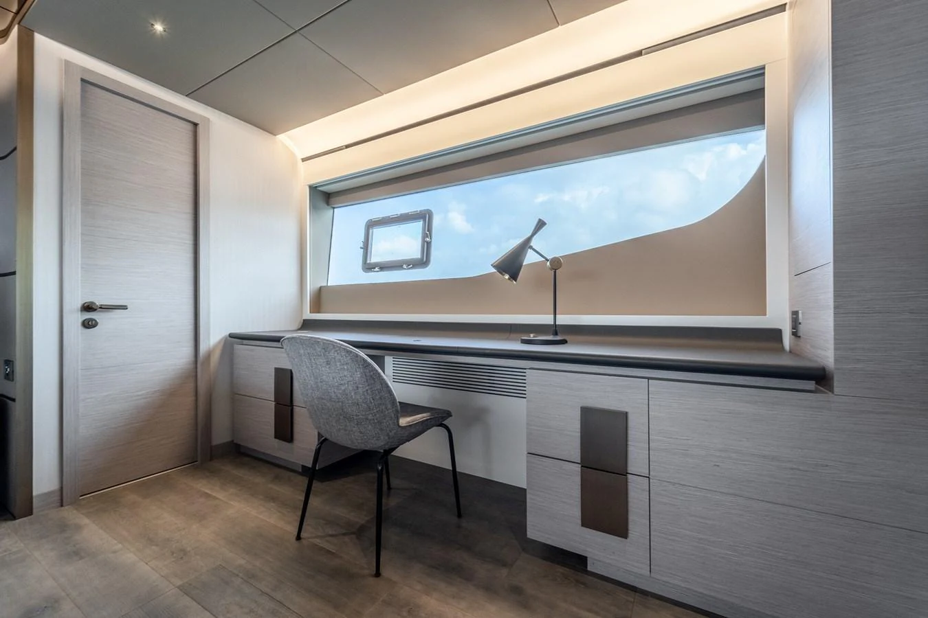 a room with a chair and a tv on the wall aboard EXIT STRATEGY Yacht for Sale