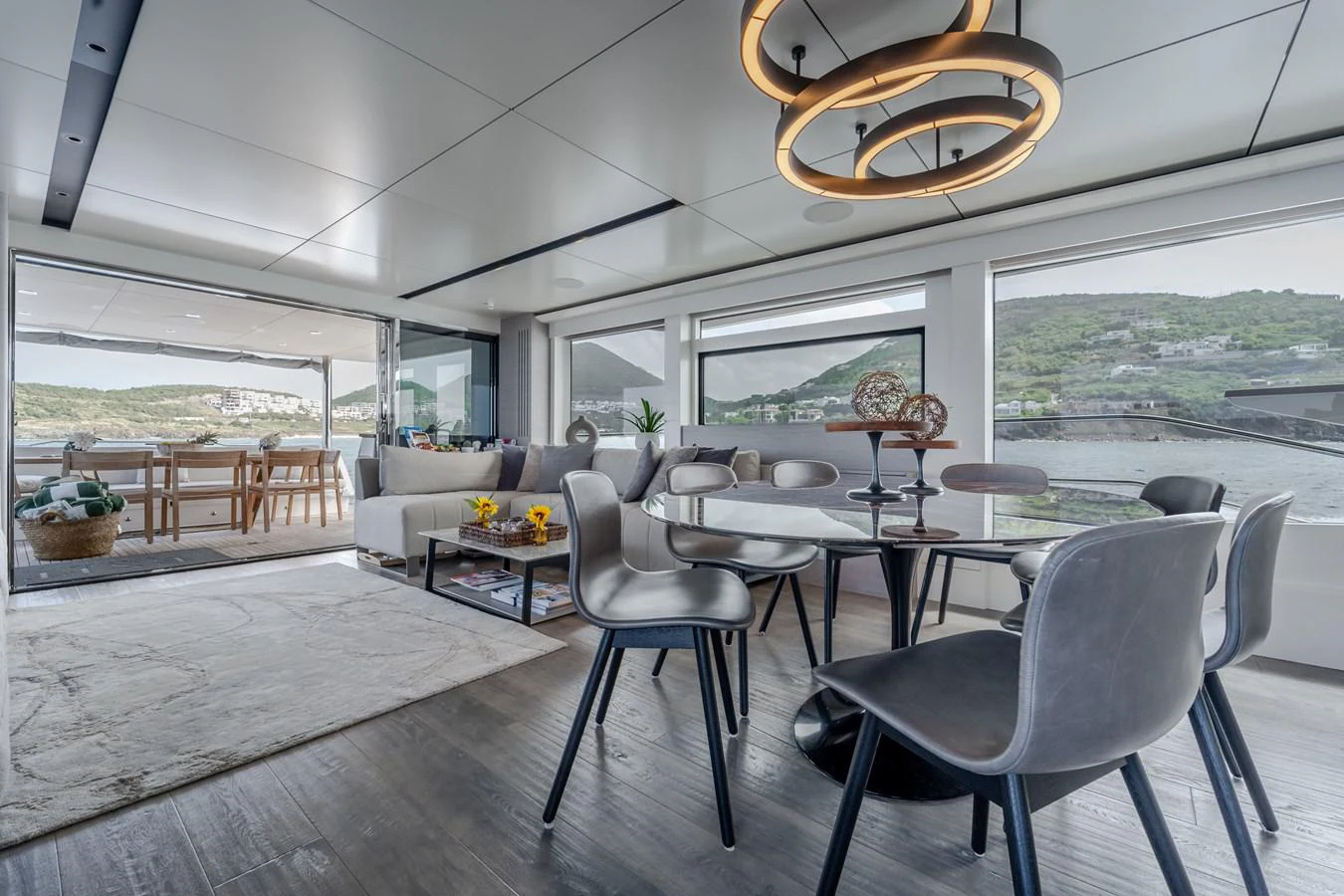 a room with a table chairs and a large window aboard EXIT STRATEGY Yacht for Sale