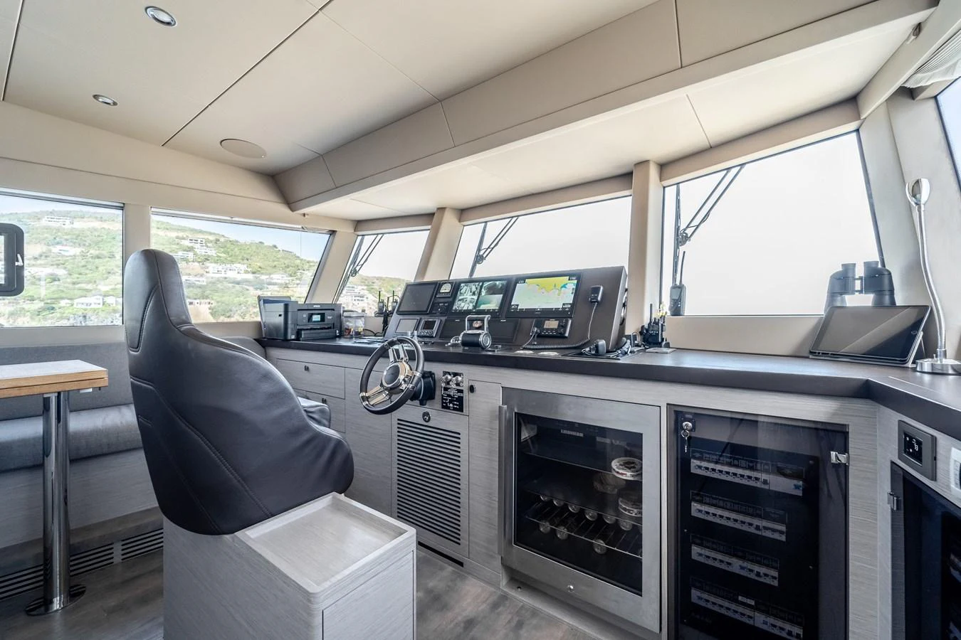 a room with a chair and a table with computers on it aboard EXIT STRATEGY Yacht for Sale