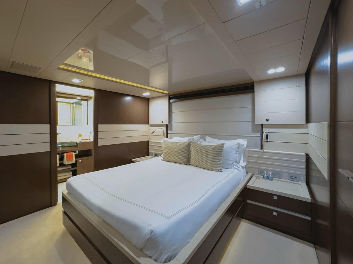 a room with a bed and a mirror aboard WHITE PEARL Yacht for Sale