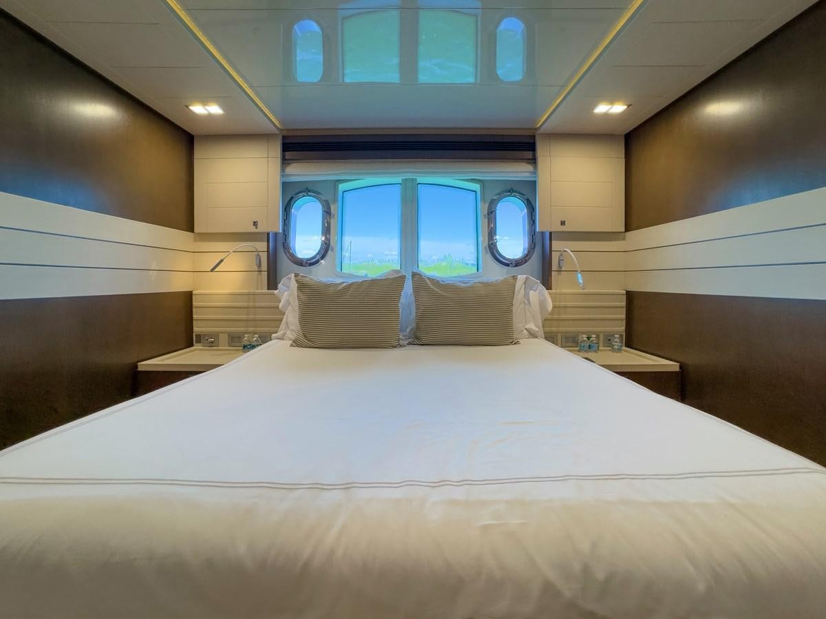 a bed with a white bed spread aboard WHITE PEARL Yacht for Sale