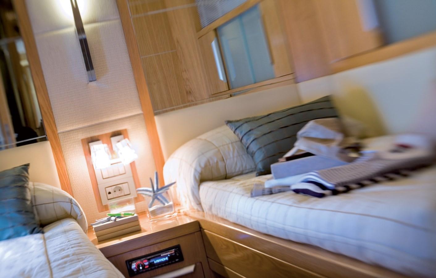a bed with a laptop on it aboard RODMAN 74 MUSE Yacht for Sale