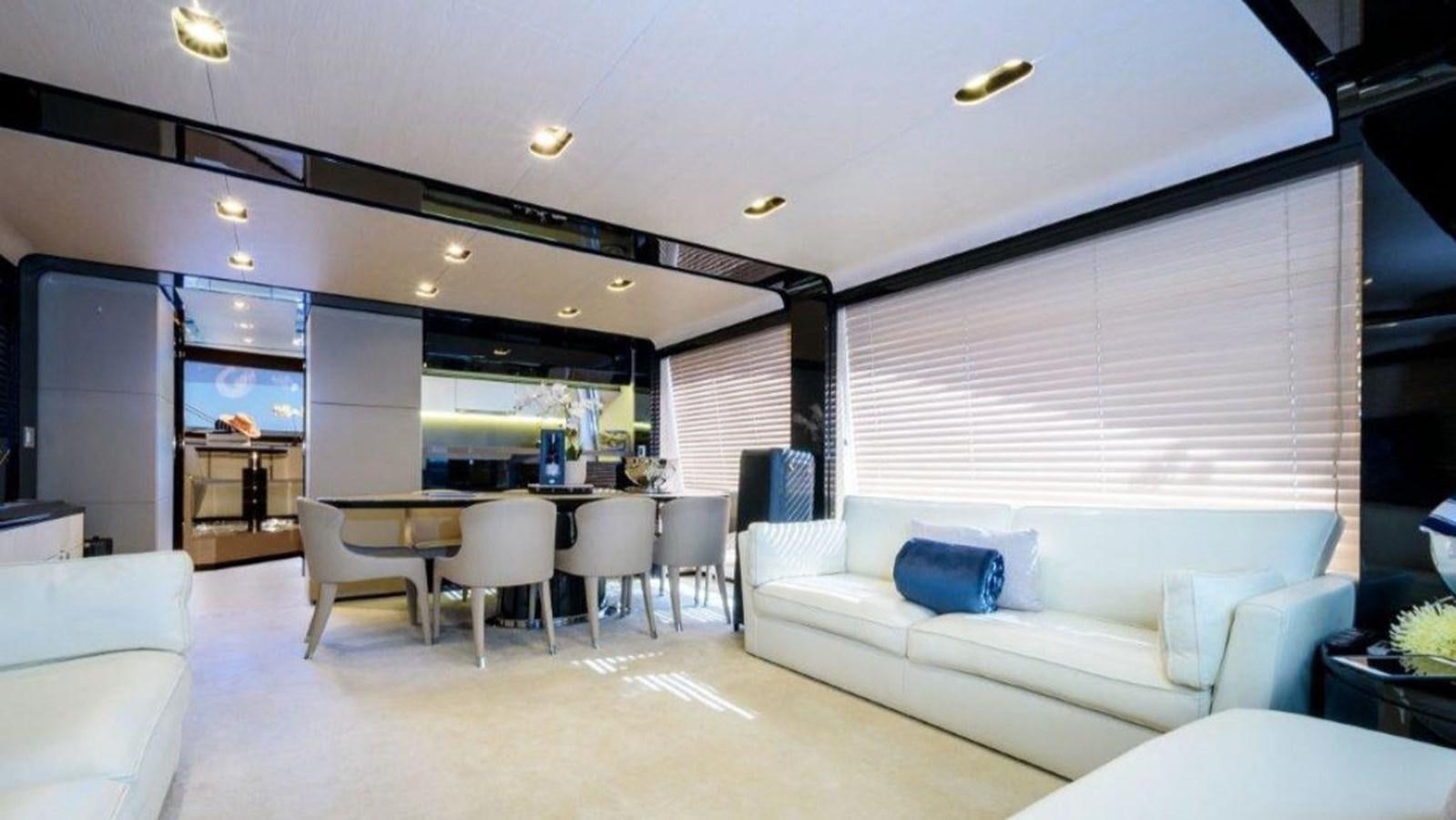 a living room with a large white sofa and a large table aboard SOLACE Yacht for Sale