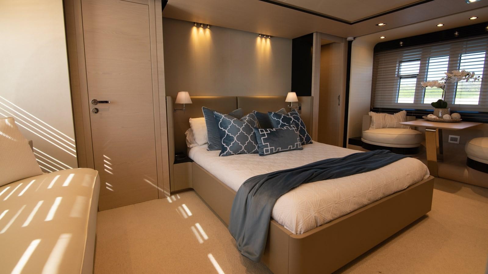 a bedroom with a bed and desk aboard SOLACE Yacht for Sale