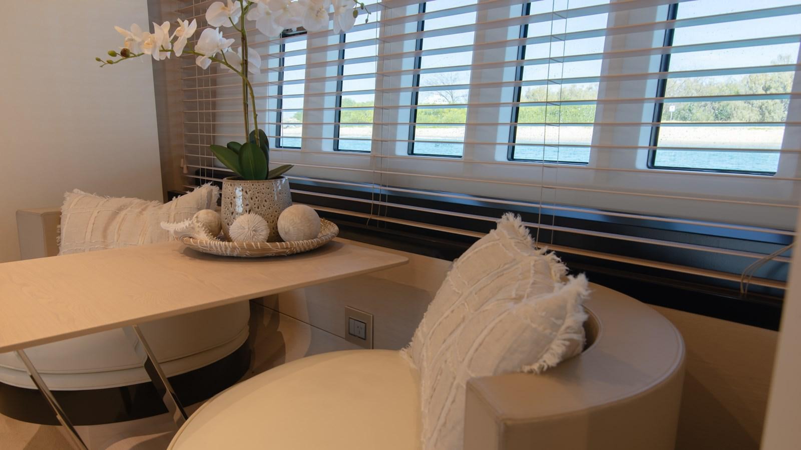 a table with a plate of food on it aboard SOLACE Yacht for Sale