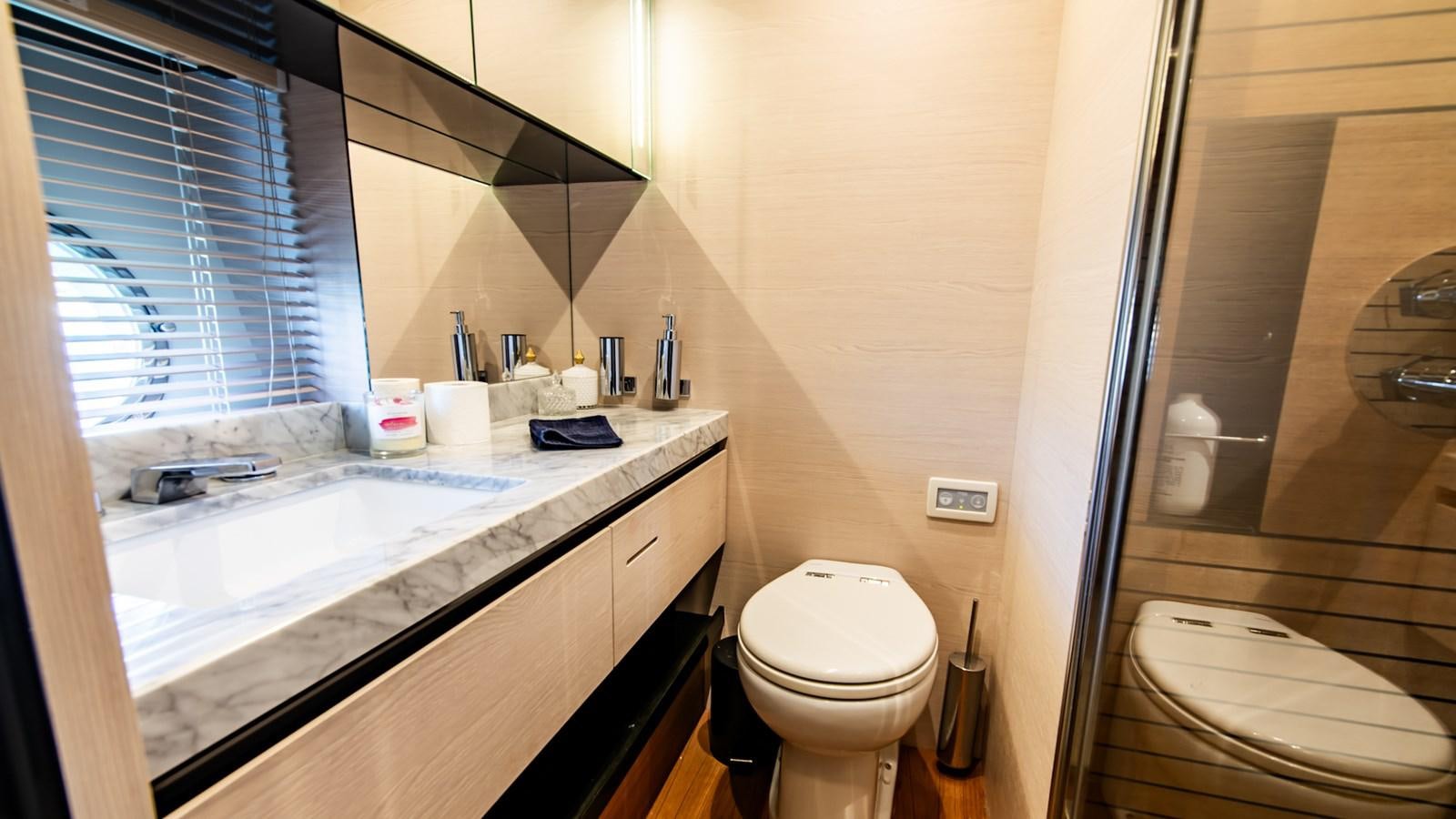 a bathroom with a sink toilet and a bathtub aboard SOLACE Yacht for Sale