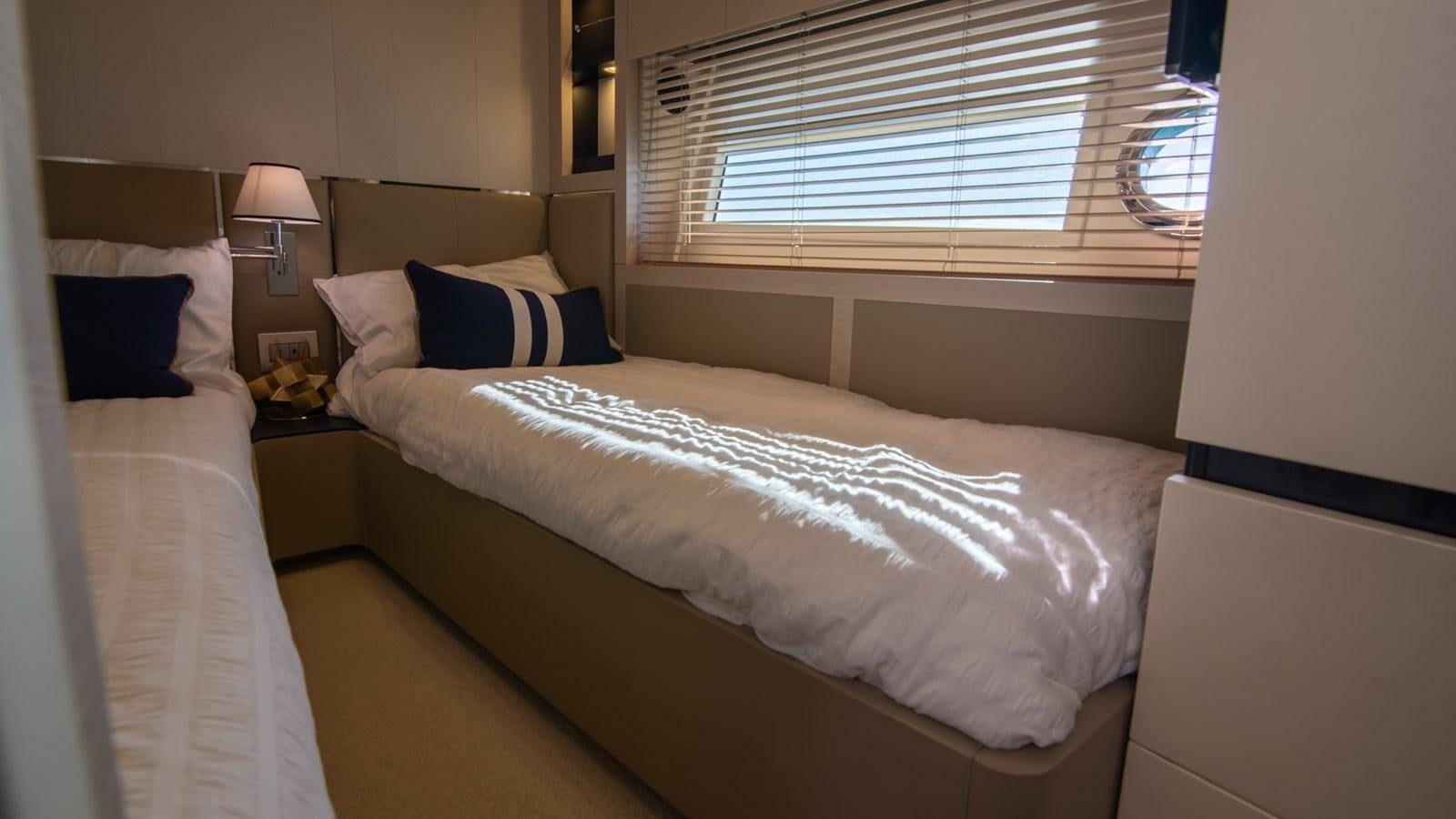 a bed with a white sheet and pillows aboard SOLACE Yacht for Sale