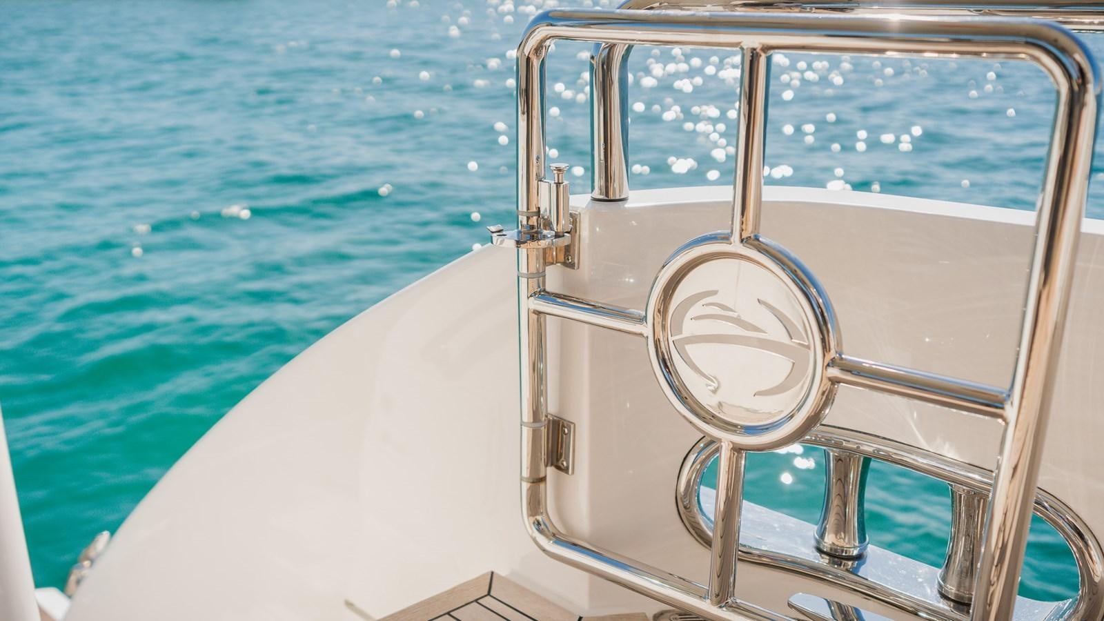 a white boat with a round white circle on the front aboard OHANA Yacht for Sale