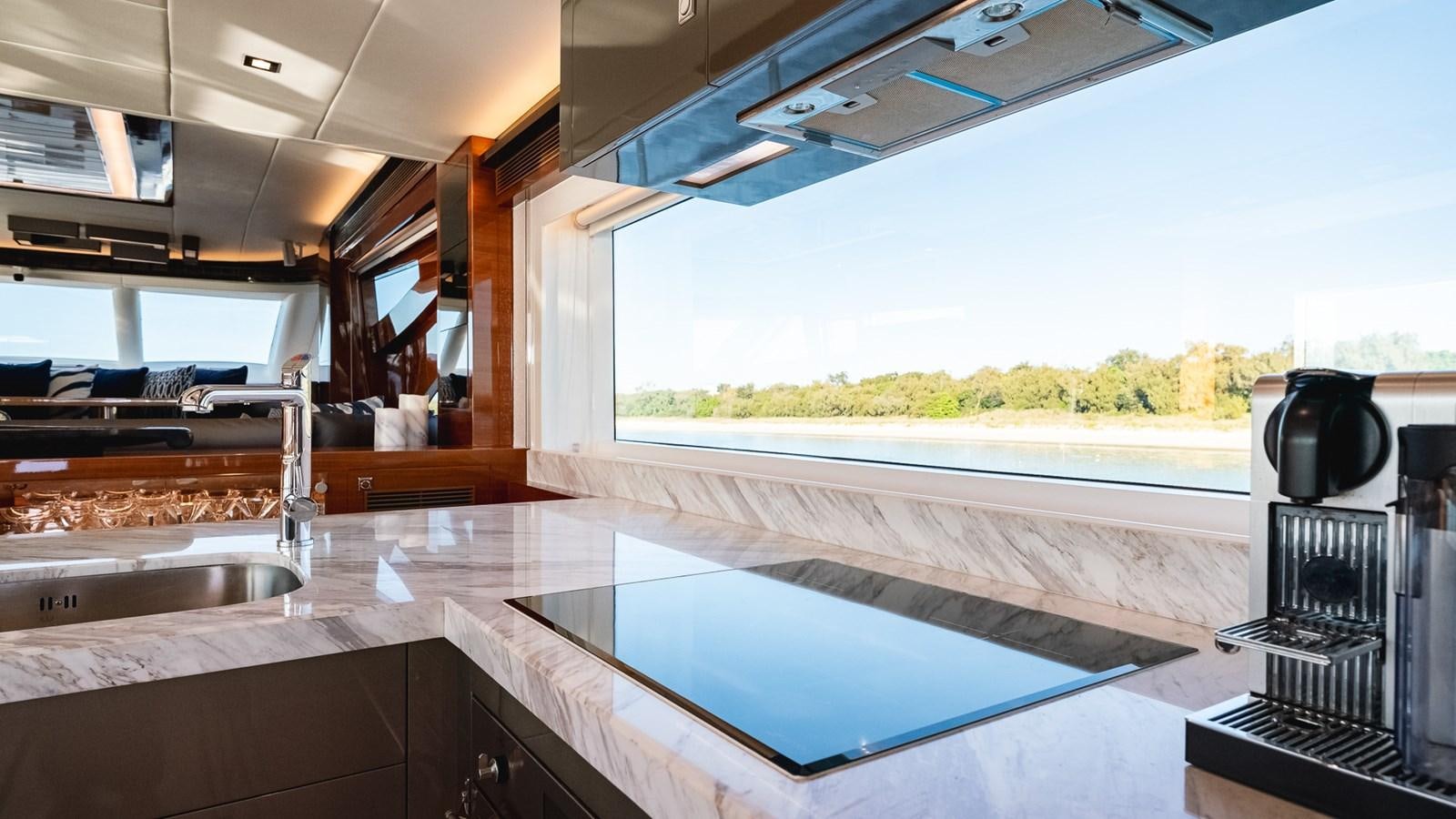 a large open kitchen with a large window aboard OHANA Yacht for Sale