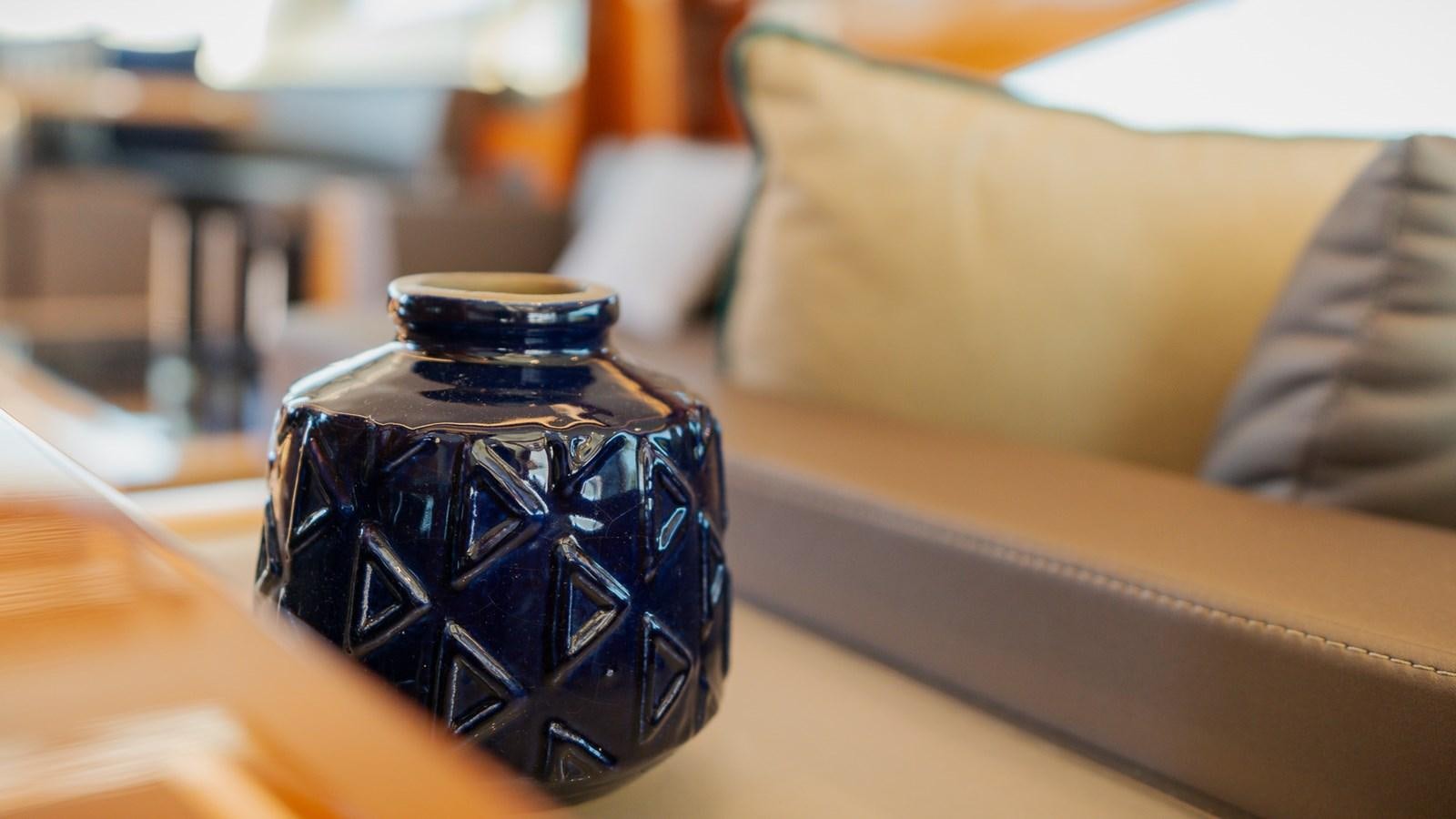 a black vase on a table aboard OHANA Yacht for Sale