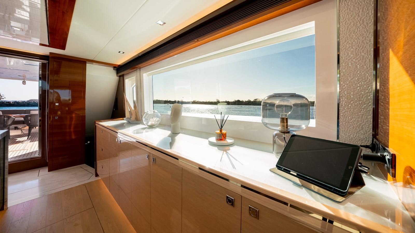 a room with a tv and a window aboard OHANA Yacht for Sale