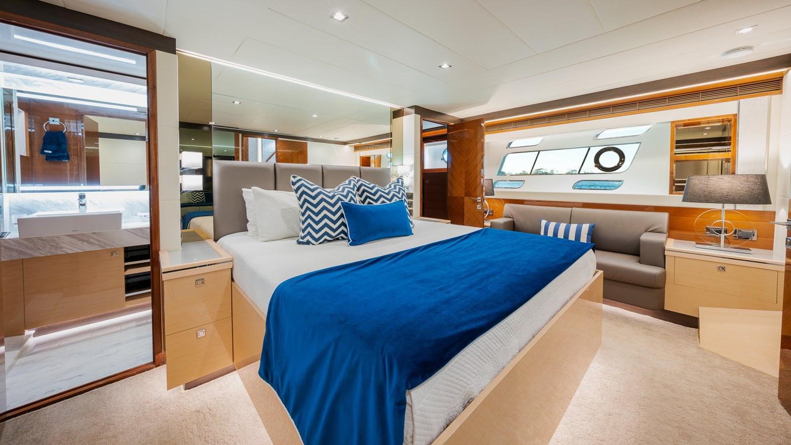 a bedroom with a bed and a couch aboard OHANA Yacht for Sale