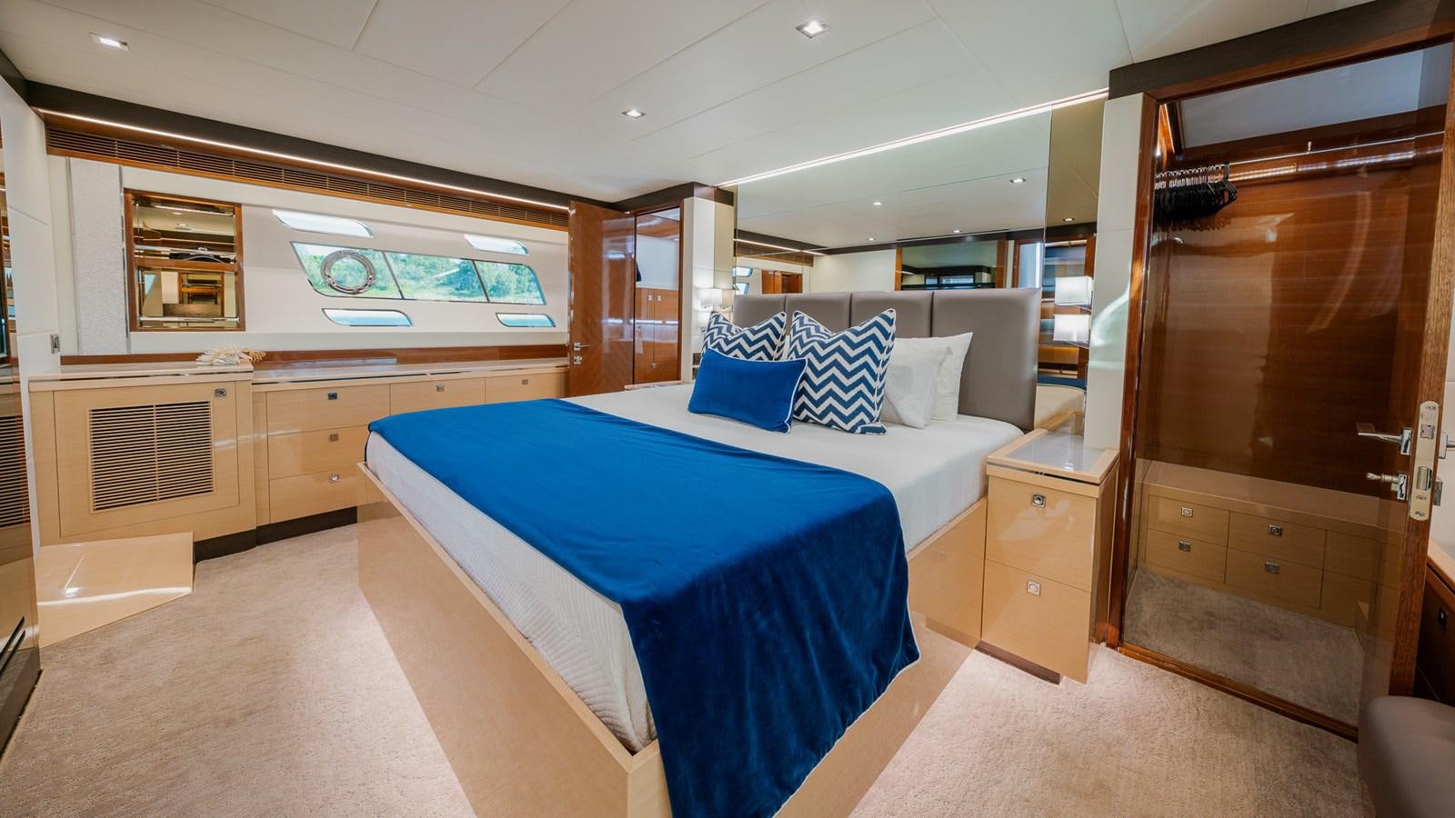 a room with a bed and a desk aboard OHANA Yacht for Sale