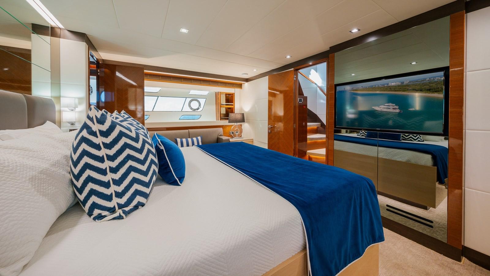 a room with a bed and a tv aboard OHANA Yacht for Sale