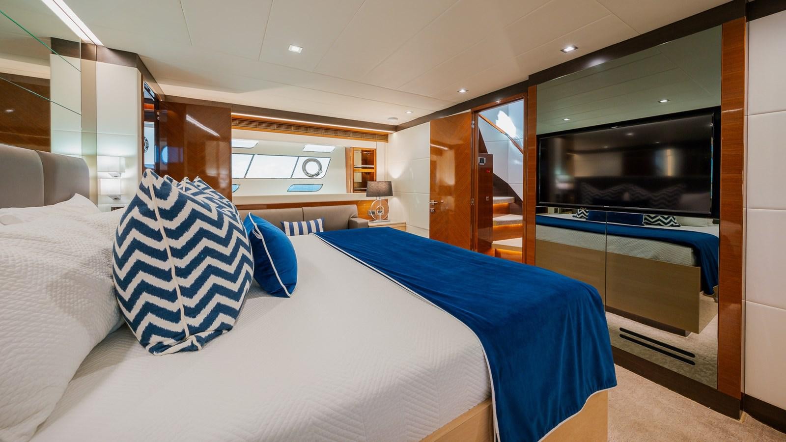 a room with a bed and a television aboard OHANA Yacht for Sale