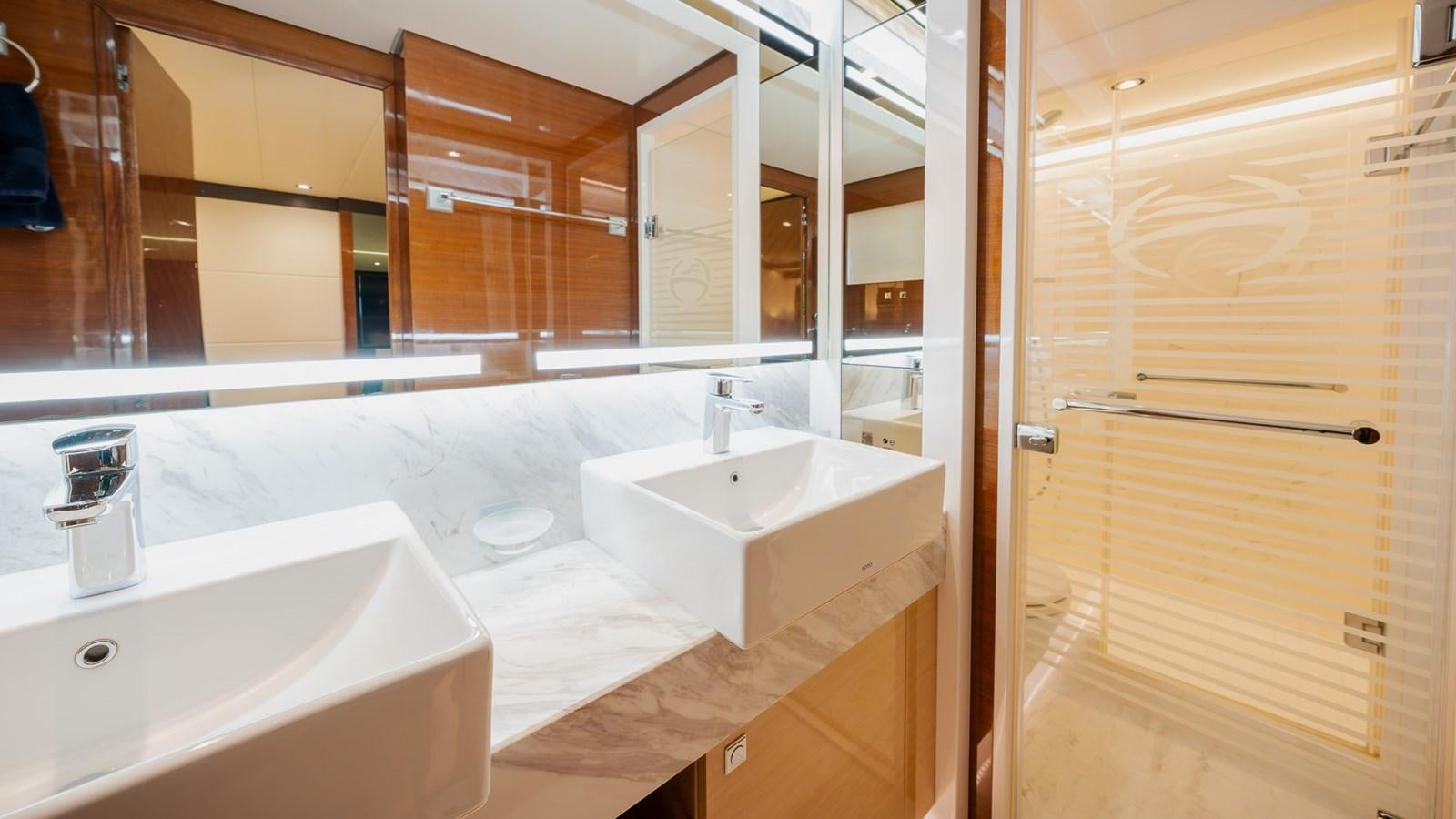 a bathroom with a countertop sink and mirror aboard OHANA Yacht for Sale
