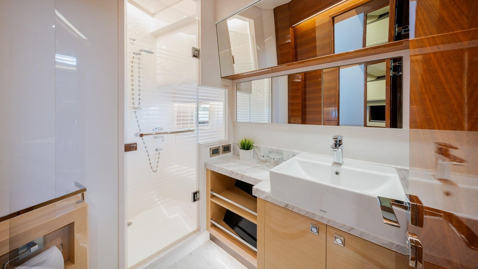 a bathroom with a sink and cabinets aboard OHANA Yacht for Sale
