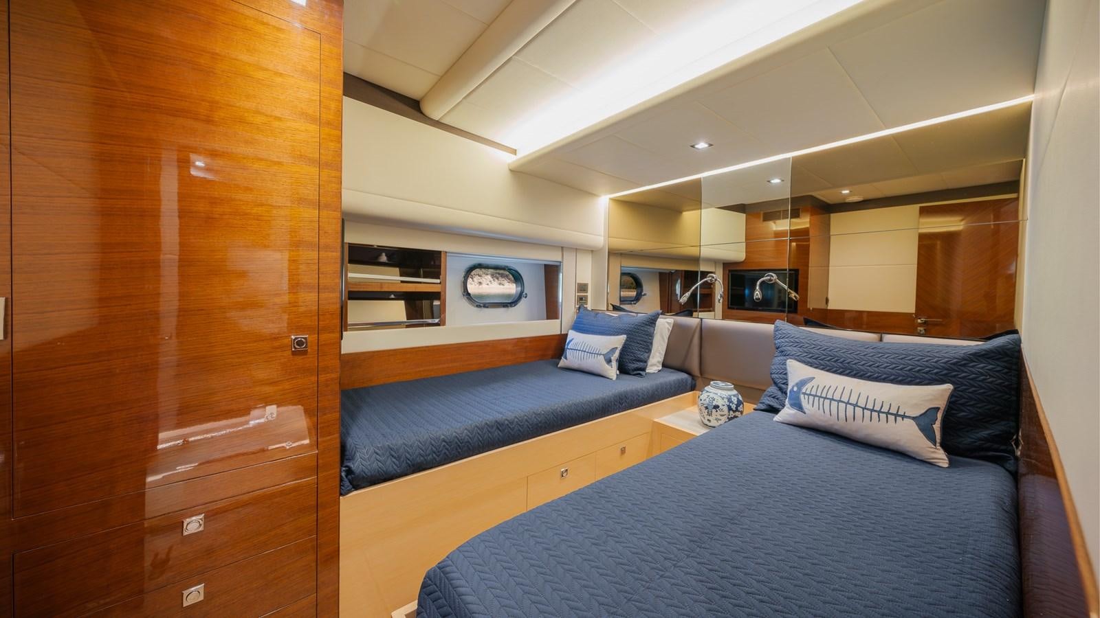 a room with a bed and a tv aboard OHANA Yacht for Sale