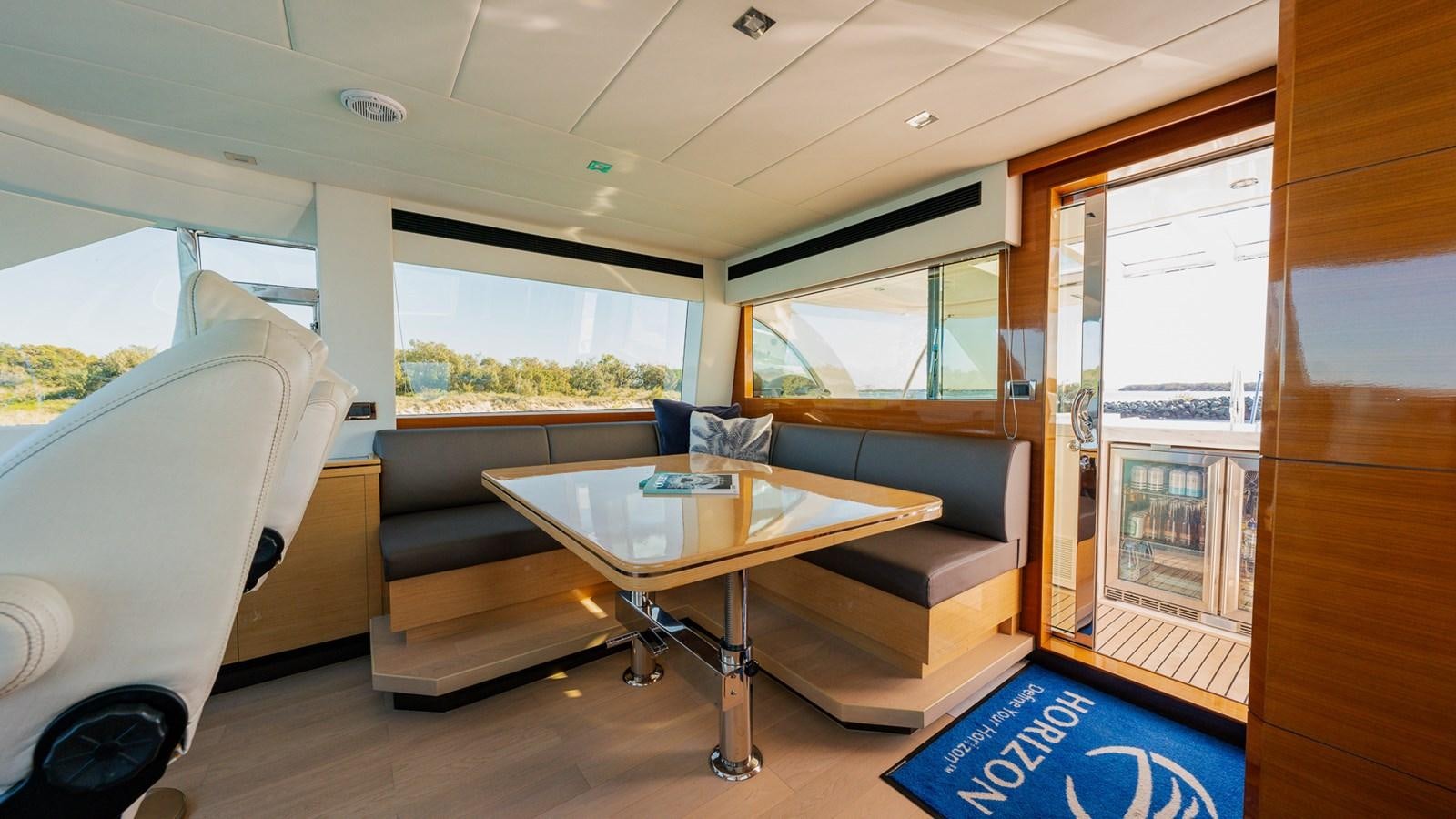 a room with a couch and a table aboard OHANA Yacht for Sale
